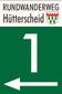 Signpost for the Hütterscheid circular hiking trail with a large white number 1 and an arrow pointing left on a green background.