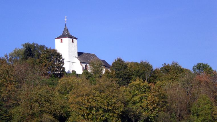 Church of St. Apollonia in Gransdorf on a wooded hill.